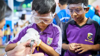 Children learning to use a drill