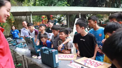 Group of children standing in line for Bosch tools