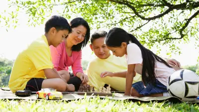 Family spends time together playing at the park.
